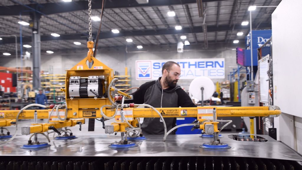 sheet metal is loaded into a laser cutting system.