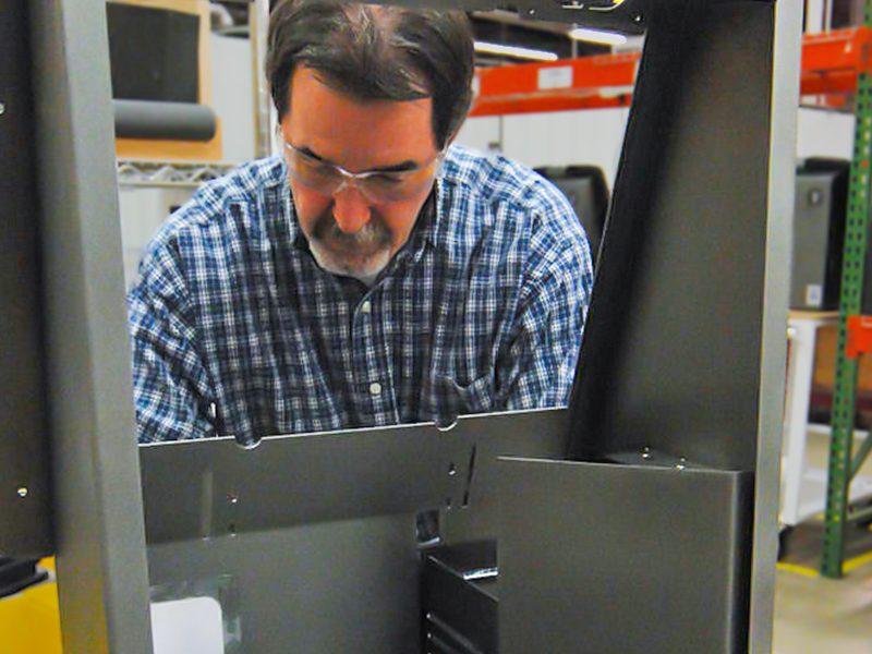 A Southern Specialties worker adds components to a security kiosk.