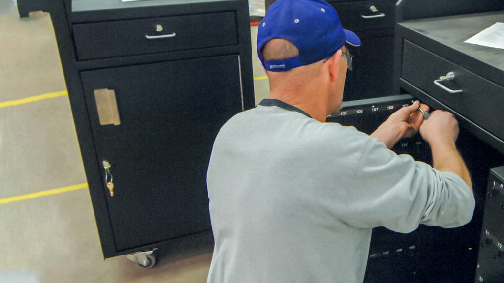 A technician installs the final pieces of a custom product manufacturing project